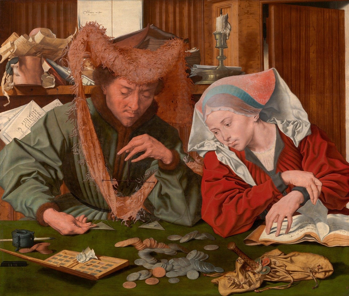 A moneychanger weighs coins on a small balance while his wife turns the pages of an account book, coins spread on a green table