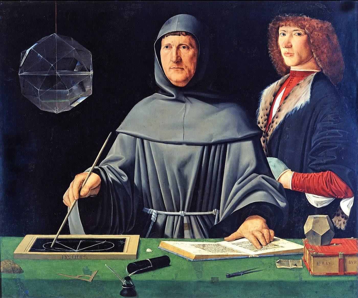 Painting of Luca Pacioli in a grey friar’s habit at a green table with a slate, a book and a glass polyhedron, a young man standing beside him